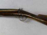 a close up of a rifle on a table with a white background