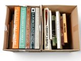 many books in a box on a white surface