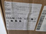 a brown box with a label on it that has a sticker on it
