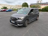 a grey van that is parked in a parking lot