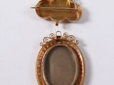 two gold lockes with a picture in the middle of them