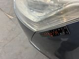 a close up of a car ' s headlight on the street