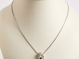 silver necklace with black stones on a white mannequin