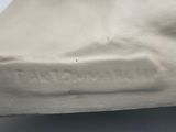 a white sculpture of a foot on a white surface