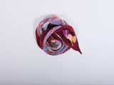 purple, red, and yellow yarn on a white surface