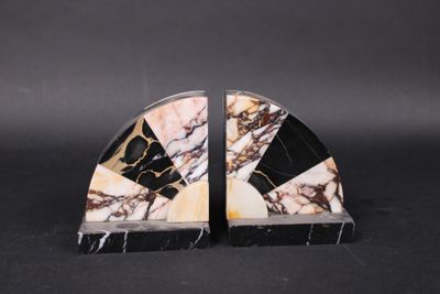 pair of black and white marble bookends on black background