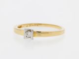 a gold and diamond ring with a single stone in the middle