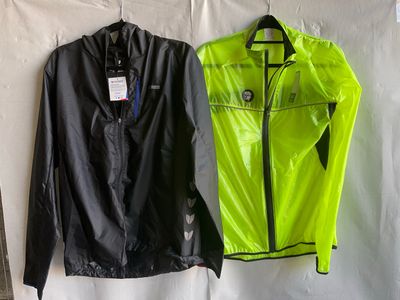 two jackets hanging on a wall with tags on them