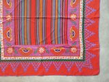an image of a red table cloth with a colorful border