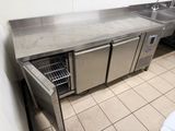 a stainless steel counter top with a sink and a dishwasher
