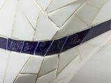 a close up of a vase with a blue ribbon on it