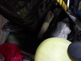 a yellow ball sitting on top of a pile of trash