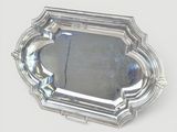 a silver tray with a mirror in it on a table