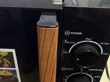 a microwave that has a wooden handle on it