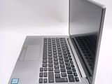 a silver laptop computer sitting on top of a white table