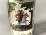 a shot glass with a picture of a man riding a horse
