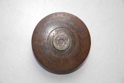 a metal object on a white surface with a white background