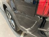 a close up of a car ' s rear end with the door open