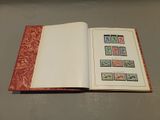 an open book with stamps on it sitting on a table