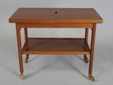 a small wooden table with a drawer on top of it