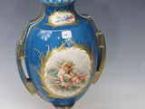 a blue vase with a painting on it sitting on a table
