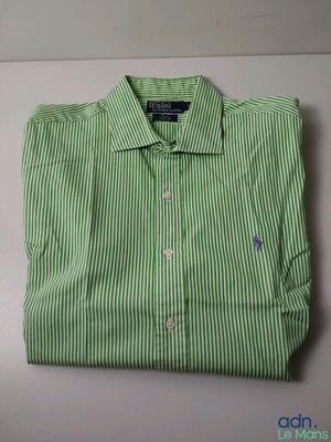 a green and white striped shirt sitting on top of a table