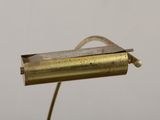 an image of a brass plated lamp with a cord attached to it