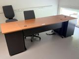 a desk with two chairs and a chair in the room