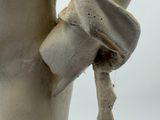 a statue of a woman with a hat and gloves on