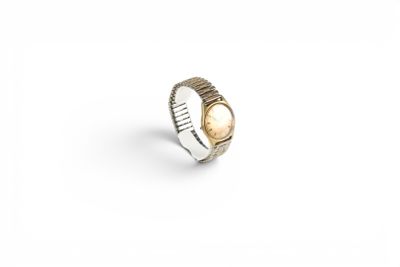 a gold and silver ring on a white background