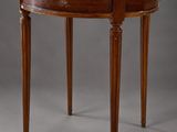a round table with a marble top and wooden legs