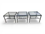 three tables with glass tops on a white background