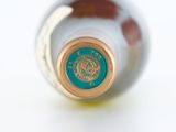 a close up of a bottle of wine on a white surface