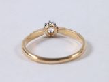 a close up of a diamond ring on a white surface