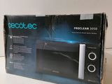 an open box of a microwave sitting on top of a counter