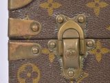 a small brown trunk with a lock on it
