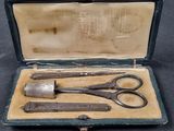 two pairs of scissors in a case on a table