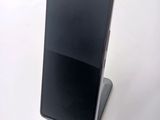 a phone that is sitting on a stand on a table