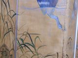 a room divider with a painting of a bird on it