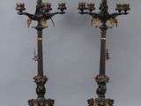 pair of antique bronze candlesticks with eagle heads and flowers