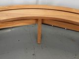 a curved wooden bench with a curved top
