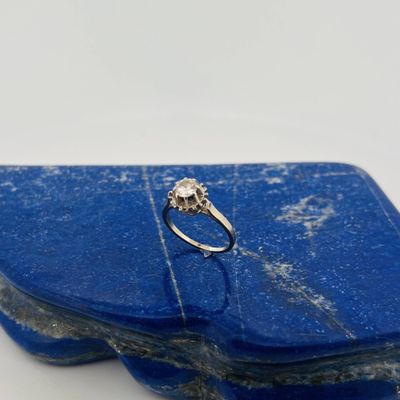 a close up of a diamond ring on a blue stone
