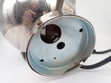 a silver tea kettle with a blue lid and a black cord