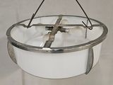 a hanging light that has a cross on it