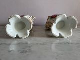 two vases that are sitting on a marble table