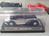 two models of cars in a display case on a table