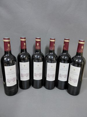 six bouteilles de vin alignées sur une table
