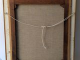 an image of a picture frame with a rope hanging from it