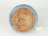 an image of a blue and brown bowl with a white cord plugged into it
