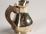 a silver pitcher that is sitting on a table